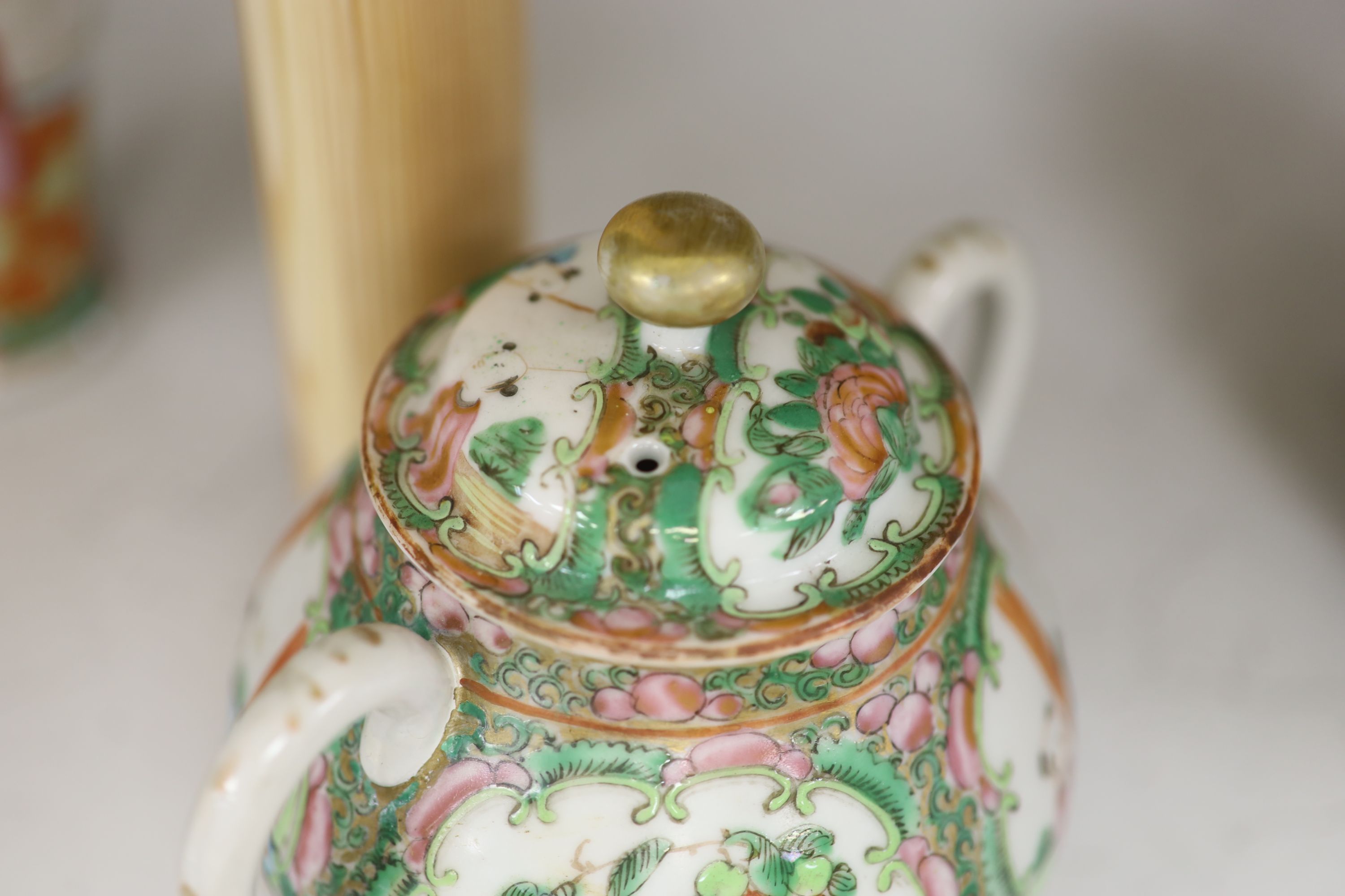 A Chinese famille rose box and cover, two vases, a sugar bowl and cover and a saucer, late 19th/early 20th century, tallest 19cm